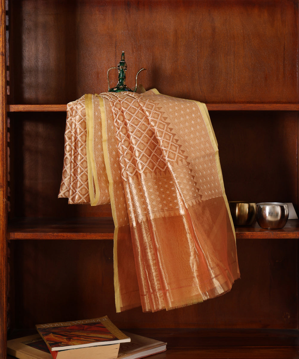 Gold handloom Kora tissue Jamdani dupatta draped over a wooden cabinet, showing the richly woven surface and softly luminous finish