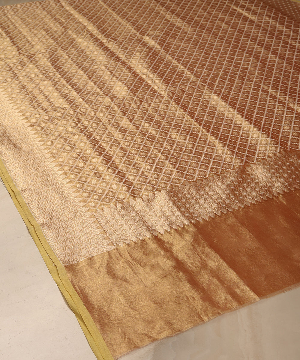 Close-up of gold handloom Kora tissue dupatta showing fine cutwork Jamdani, a geometric border and luminous end section.