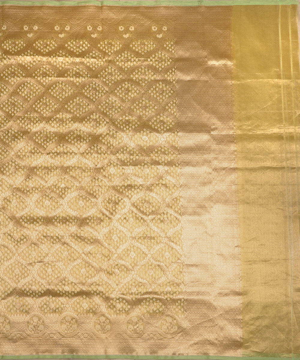Full view of lemon handloom Kora tissue Banarasi dupatta with a gold diamond Jamdani pattern, floral medallion border and pale-green edging.
