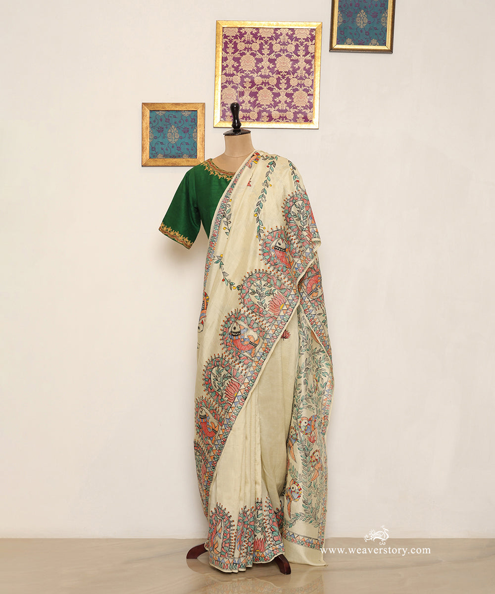 Full drape of cream Chanderi saree with painted fish and lotus border panels.