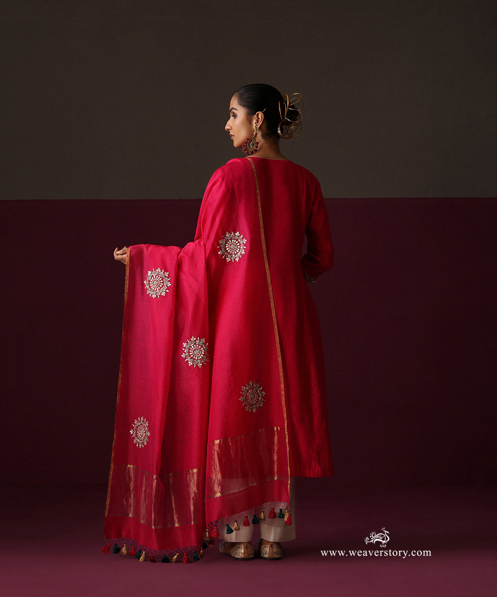 Back view of the hot pink suit and dupatta with spaced round floral bootas and metallic border