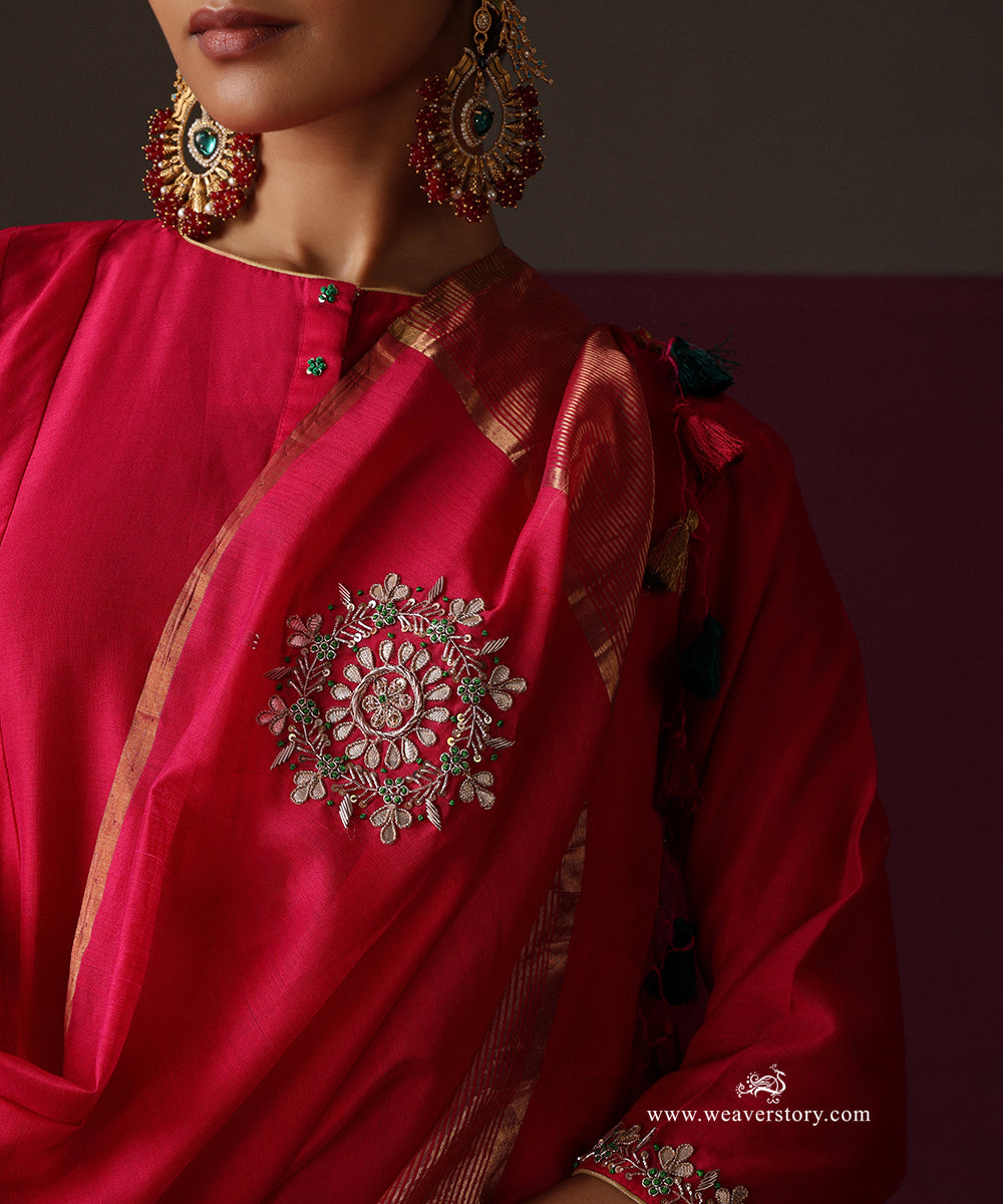 Close-up of the hot pink kurta neckline with green button accents and an embroidered floral boota on the dupatta