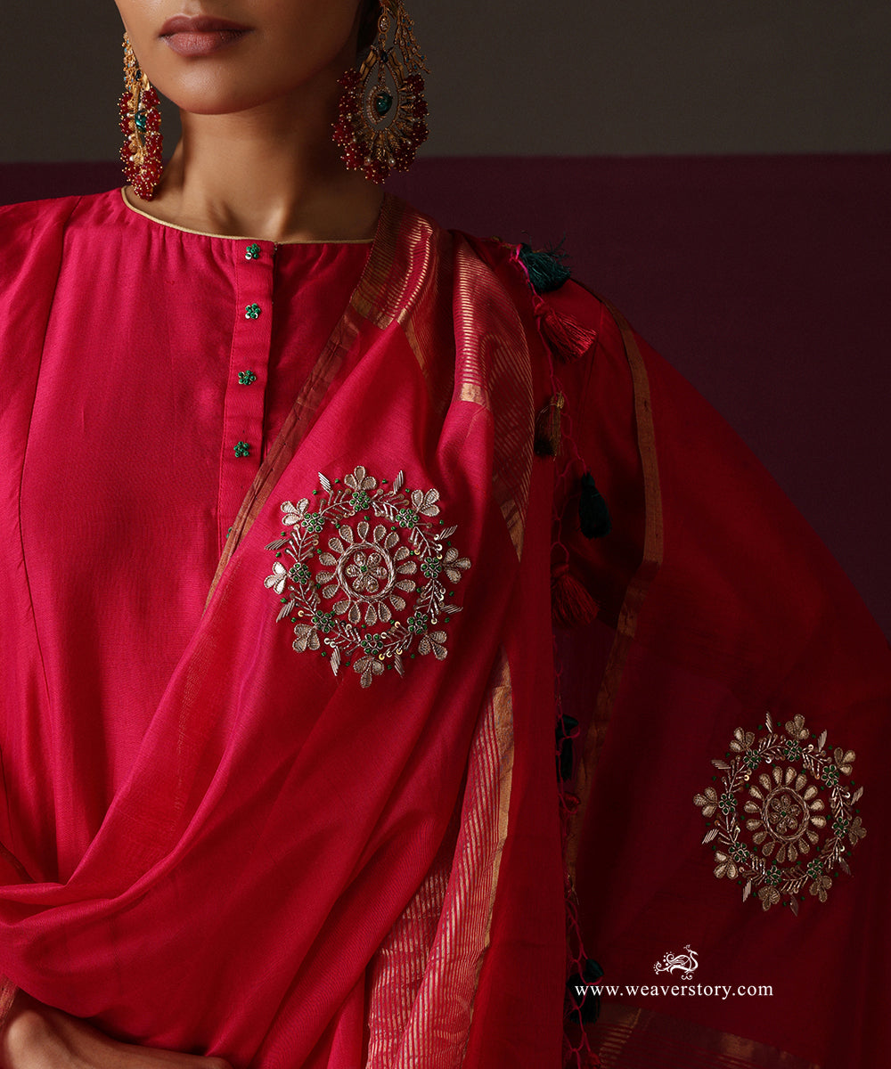 Detail of the round floral rangoli boota, metallic dupatta border and tassels in pink, green and gold