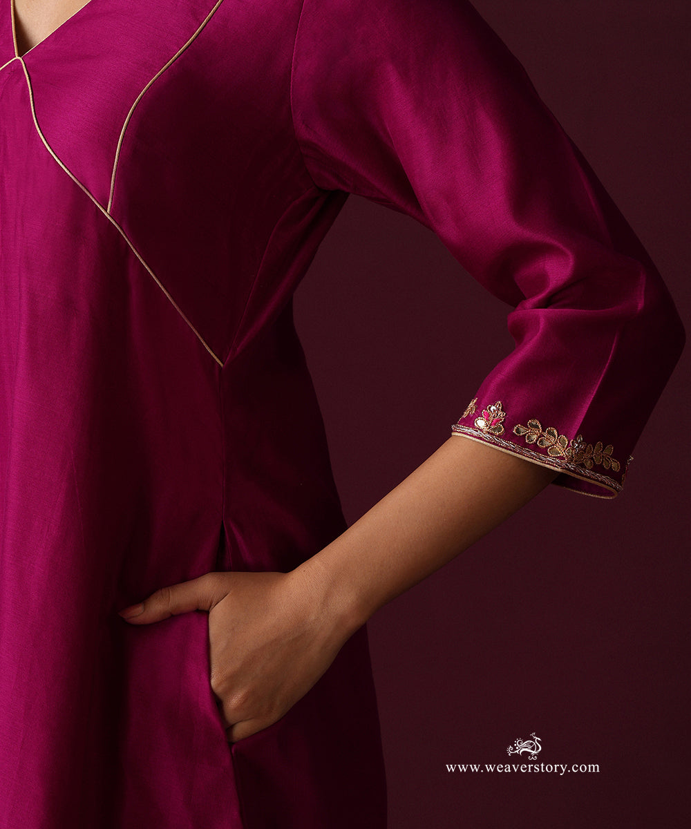 Close-up of the gold-piped bodice panels and floral hand embroidery at the kurta cuff