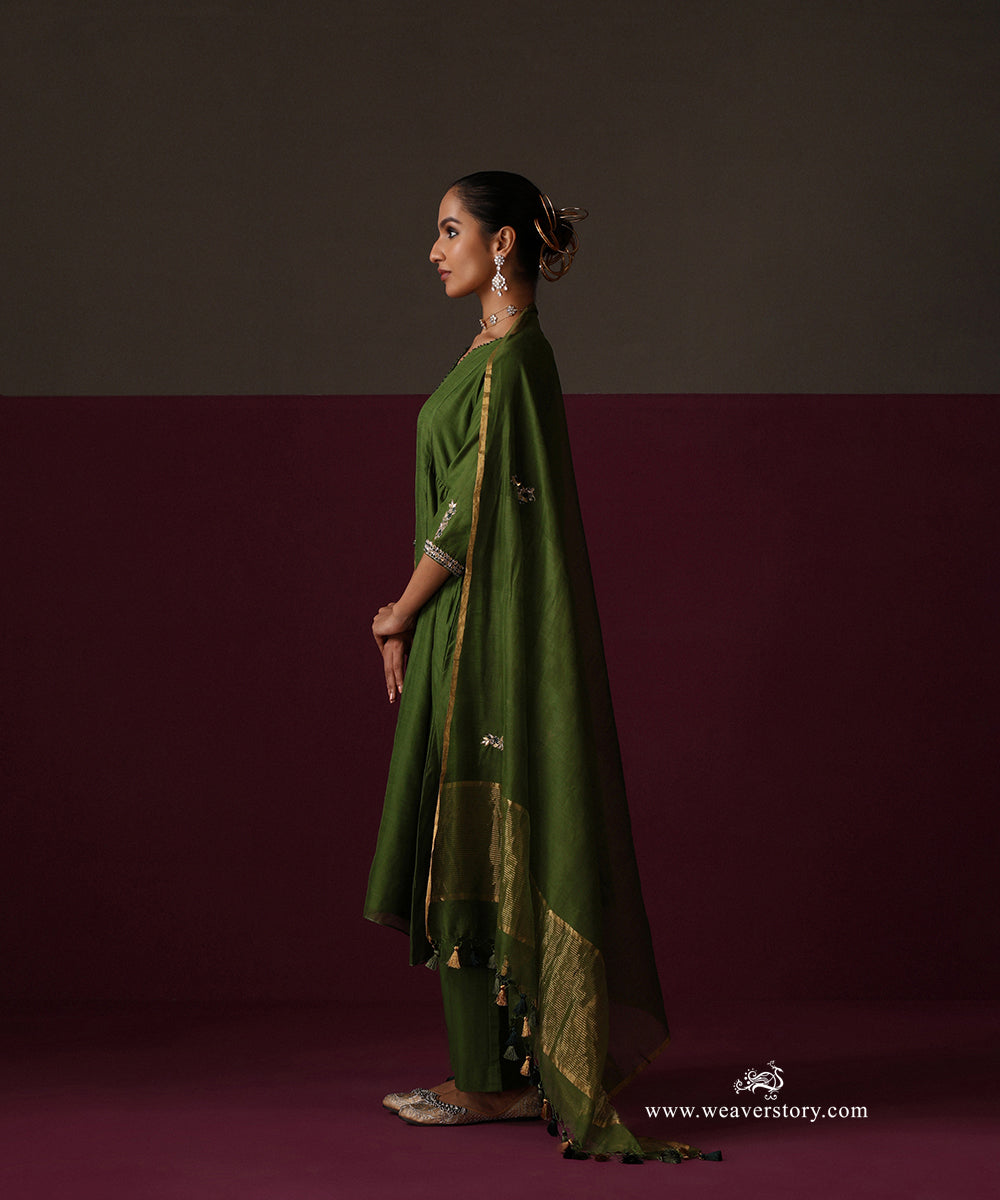 Side view of the Heena green Chanderi suit with a tasselled dupatta