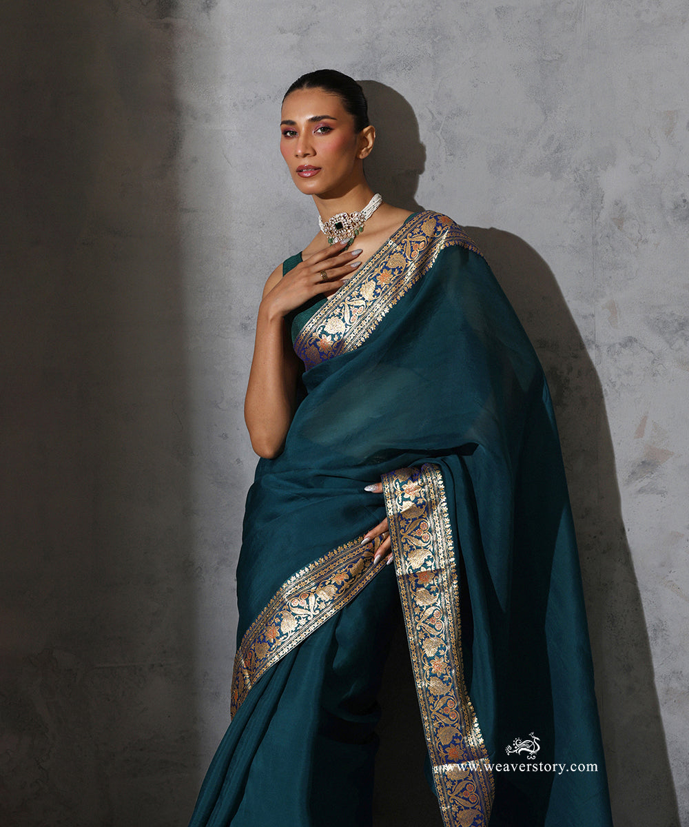Madhavi peacock blue pure silk organza saree with vintage Banarasi zari and meenakari border, full-length front view.