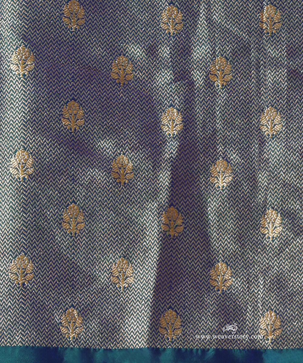 Banarasi brocade blouse fabric for Madhavi with a fine geometric zari weave and scattered floral bootis.
