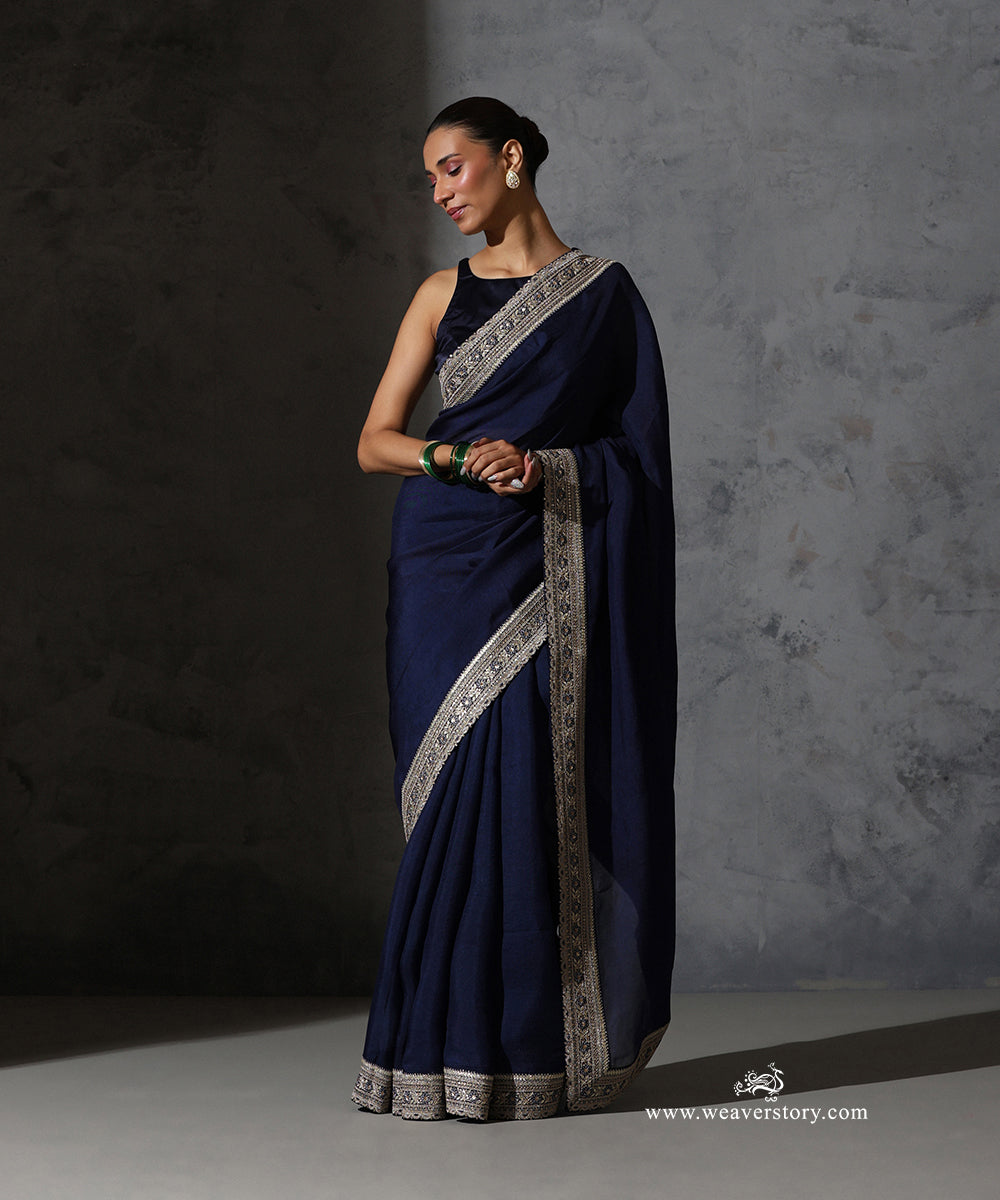Full-length front view of Tarini navy blue organza saree with intricate thread and zari embroidered border.