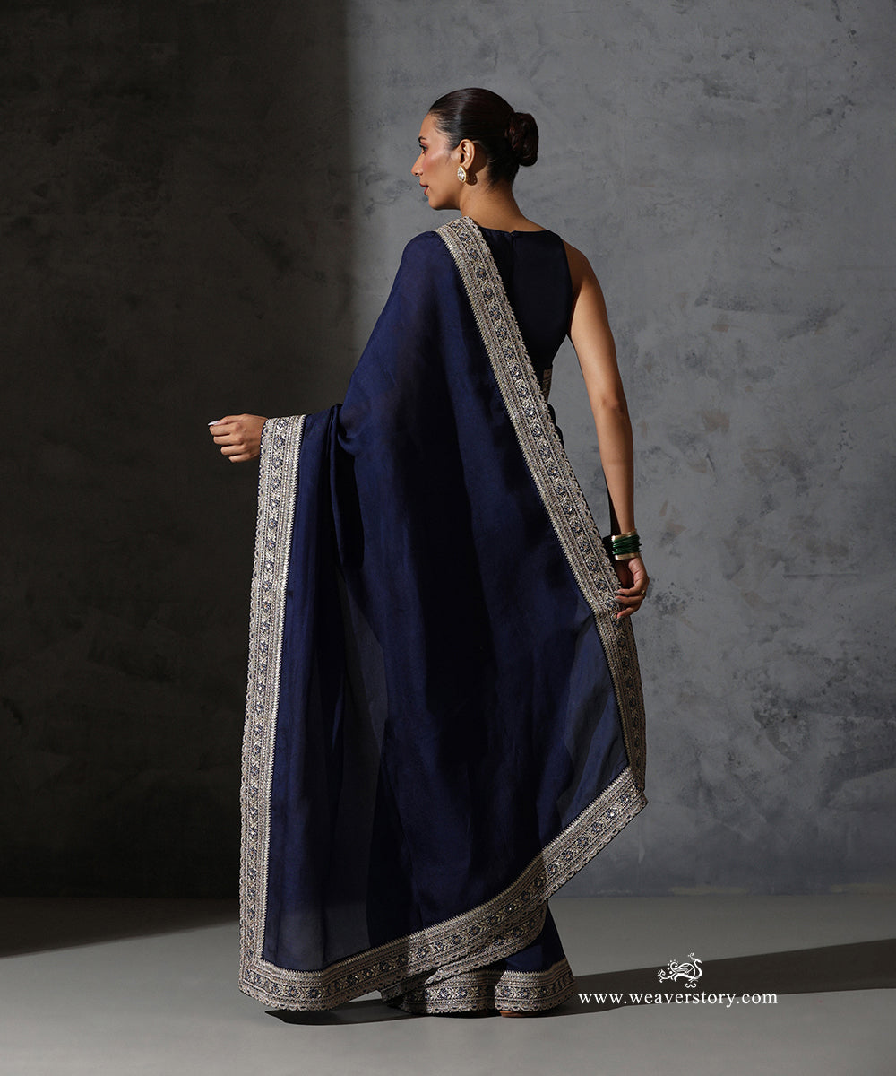 Back view of Tarini navy blue pure silk organza saree with fine thread and zari embroidered scalloped border.