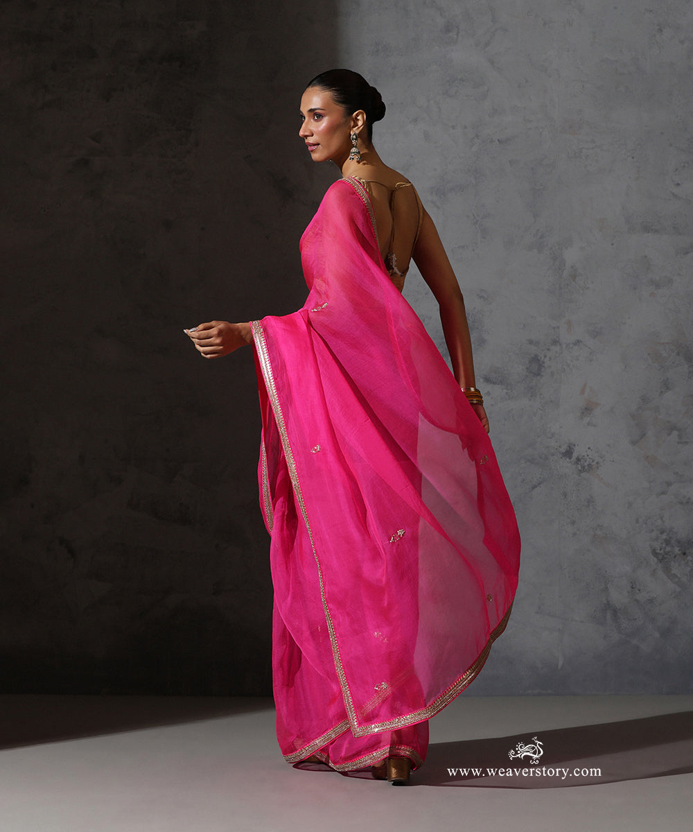 Detail of Tarini hot pink pure silk organza saree with delicate hand-embroidered zardozi bootis and fine embroidered border.