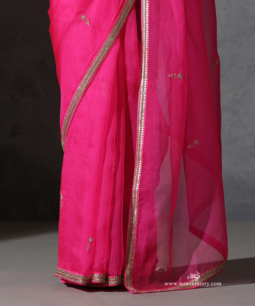 Detail of Tarini hot pink pure silk organza saree with delicate hand-embroidered zardozi bootis and fine embroidered border.