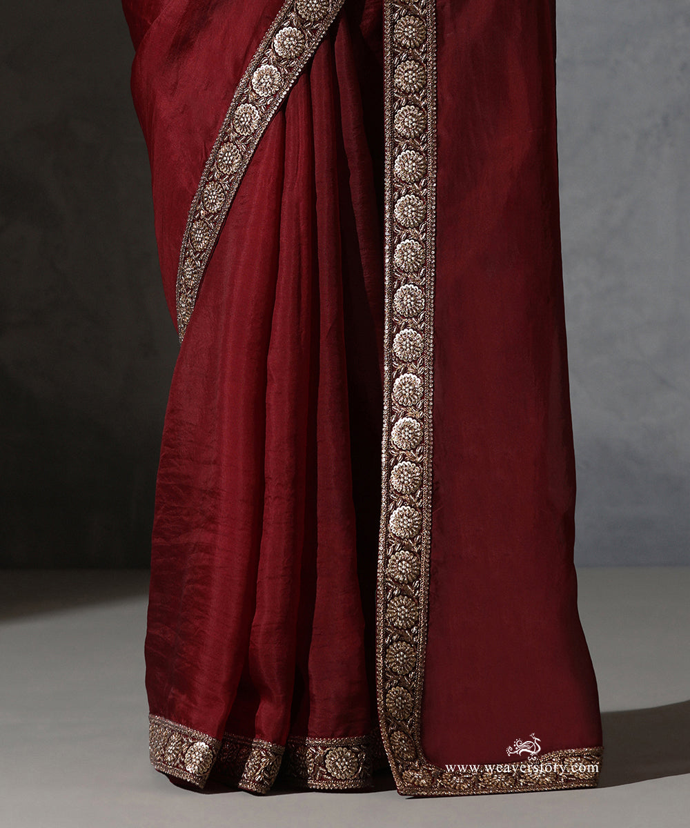 Close-up of Ragini maroon handwoven pure silk organza saree with zardozi and resham embroidered floral medallion border.
