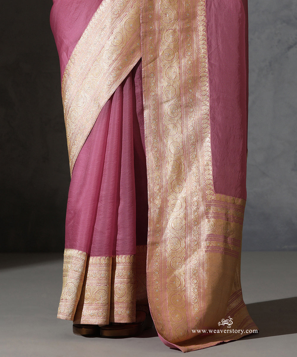 Close view of Mrignayani light pink organza saree showing the broad vintage Banarasi zari border with paisley and floral detailing.