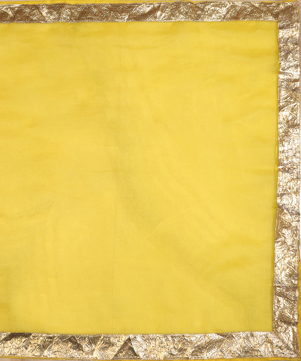 Full view of yellow silk organza dupatta with a broad handcrafted metallic lampi gota border on all four sides
