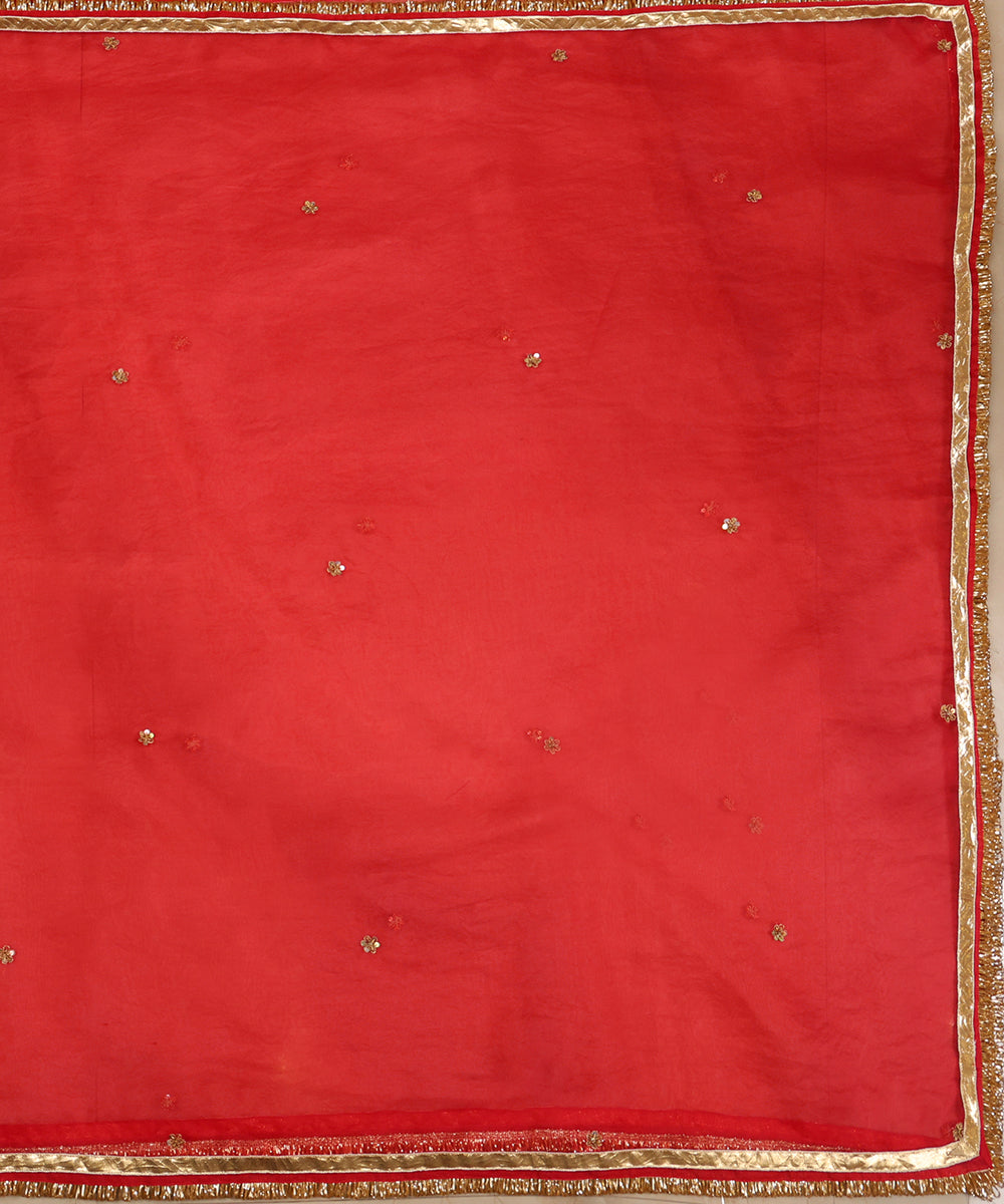 Full view of red silk organza dupatta with evenly spaced zardozi bootis, gleaming lampi gota and kiran-finished edges.