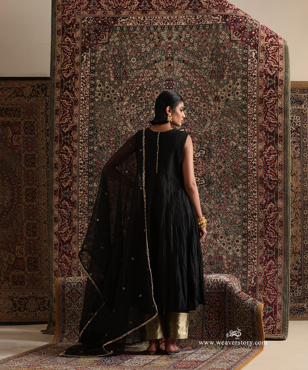 Back view of black pure Chanderi silk wrinkled Anarkali with cotton silk pants featuring a gold brocade border and pure silk organza dupatta