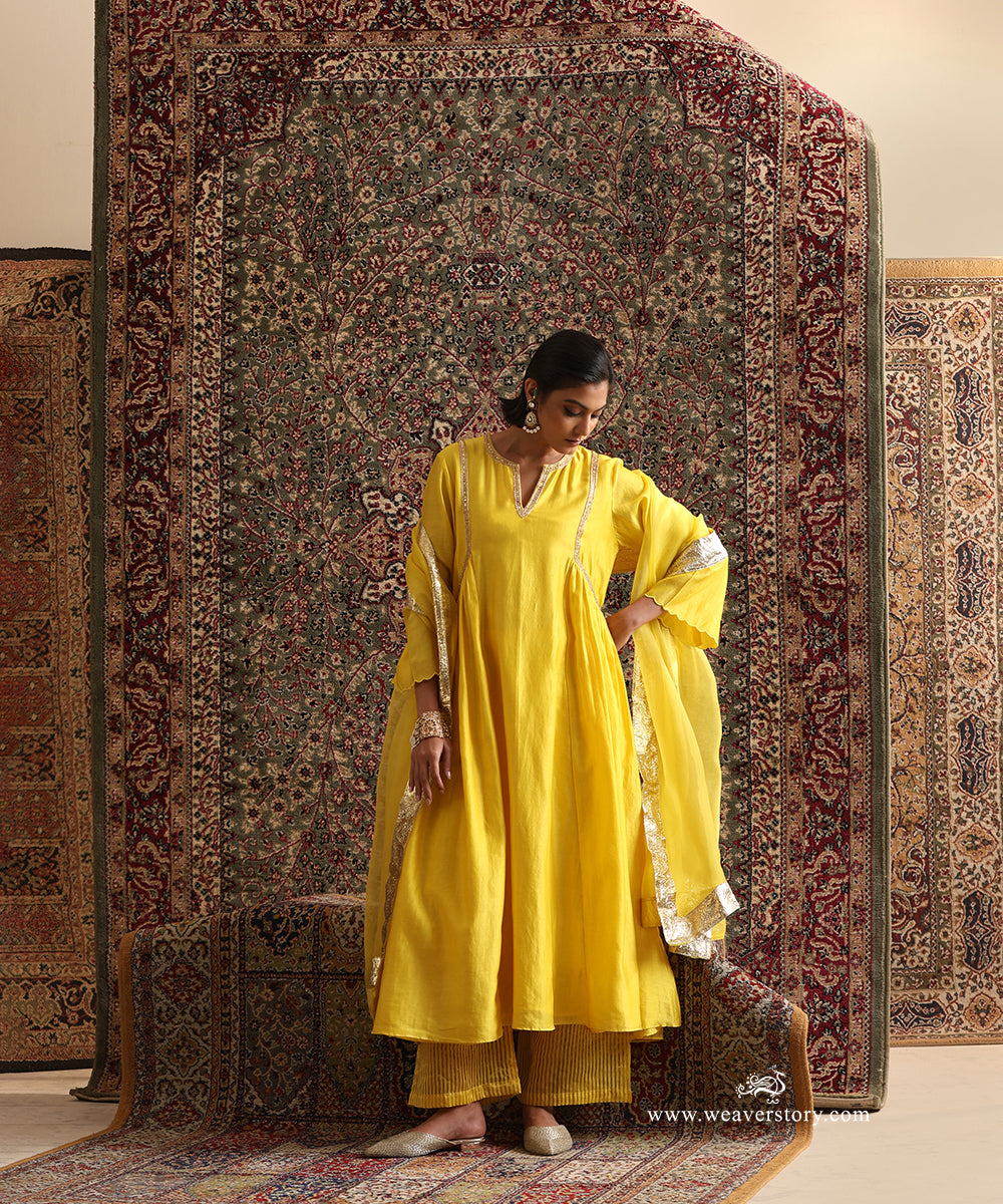 Yellow Chanderi silk kurta set with striped cotton silk pants and light organza dupatta