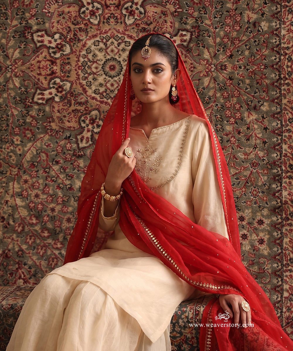 Almond Beige Organza Silk kurta and gharara set styled with contrasting red embroidered organza silk dupatta