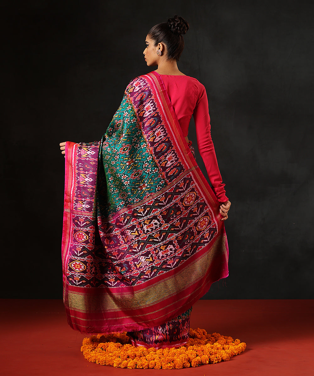 Handloom Teal Blue And Green Double Warp Pure Mulberry Silk Ikat Patola Saree With Pink Border
