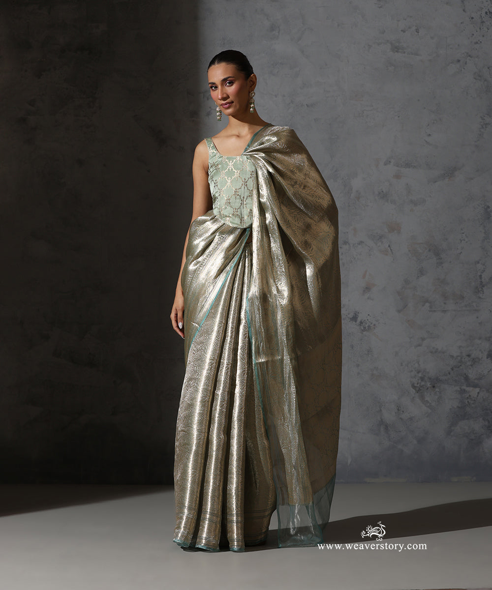 Full front view of mint green and gold Banarasi tissue saree with zari border