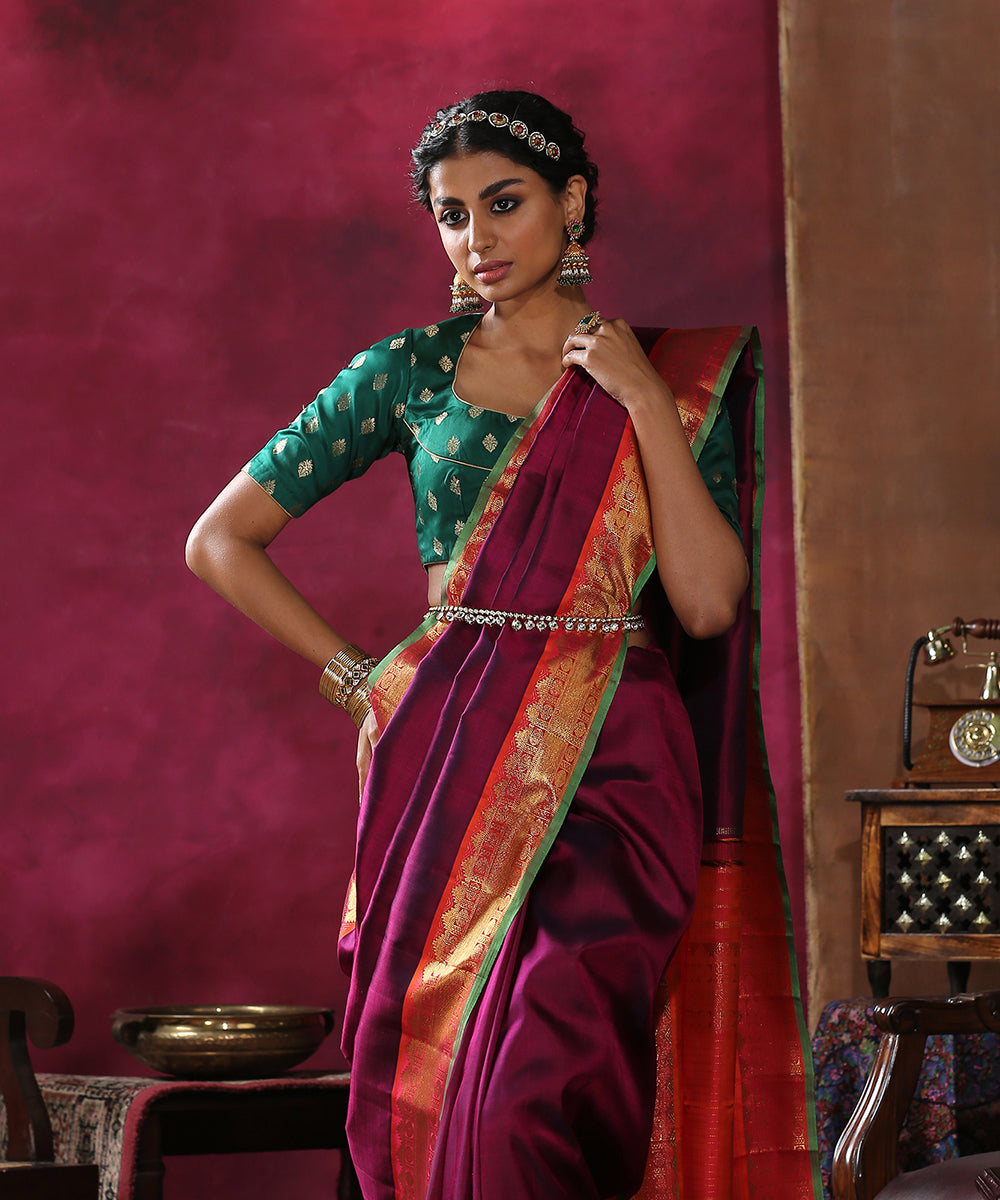 Plum_Handloom_Plain_Pure_Silk_Kanjivaram_Saree_With_Orange_And_Green_Border_WeaverStory_01