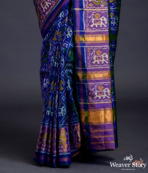 Blue_dual_tone_single_ikat_patola_saree_with_a_purple_and_gold_tissue_border_WeaverStory_04