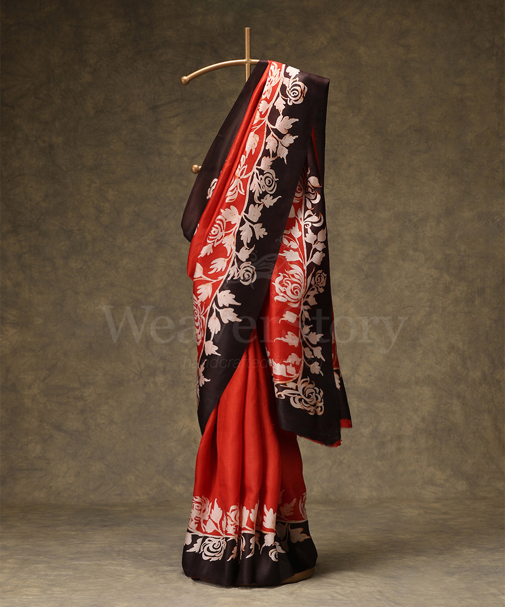 Black_And_Orange_Handloom_Hand_Batik_Mulberry_Silk_Saree_With_Floral_Border_WeaverStory_01