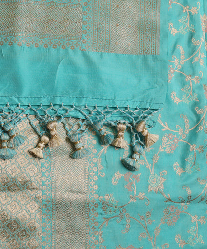 Close-up of light turquoise blue pure Katan silk dupatta with zari rose Jangla, meenakari accents and a geometric Banarasi border.
