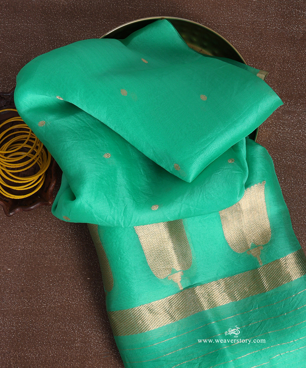 Sea green pure silk organza Banarasi dupatta with tiny gold-toned circular bootis, large chevron-patterned lotus bootas and metallic end stripes.