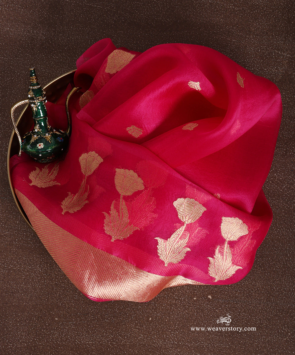 Hot pink pure silk organza Banarasi dupatta with gold-toned floral bootis, lotus blooms with leafy stems and a chevron end panel.