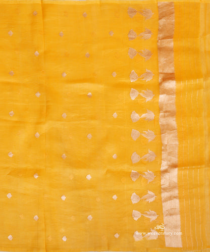 Mustard yellow Kora silk dupatta showing scattered floral bootis, a row of lotus motifs and a gold-toned chevron end panel with fine stripes.