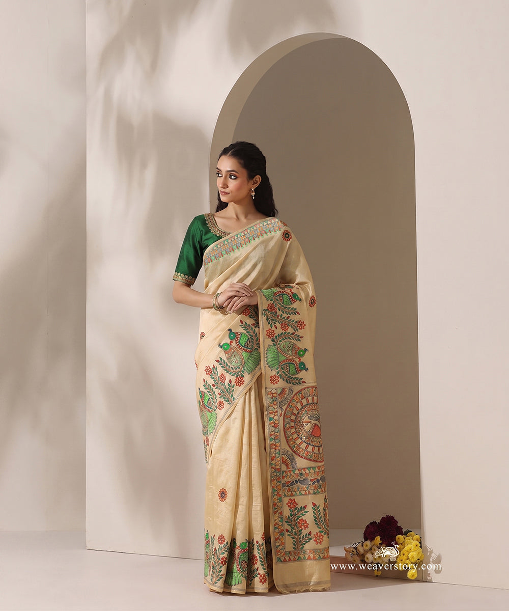 Model wearing a lemon yellow handloom Chanderi saree with Madhubani parrot borders and an intricate painted pallu