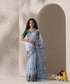 Model wearing a sky blue handloom Chanderi saree with a mandala-style Madhubani pallu and circular fish borders.