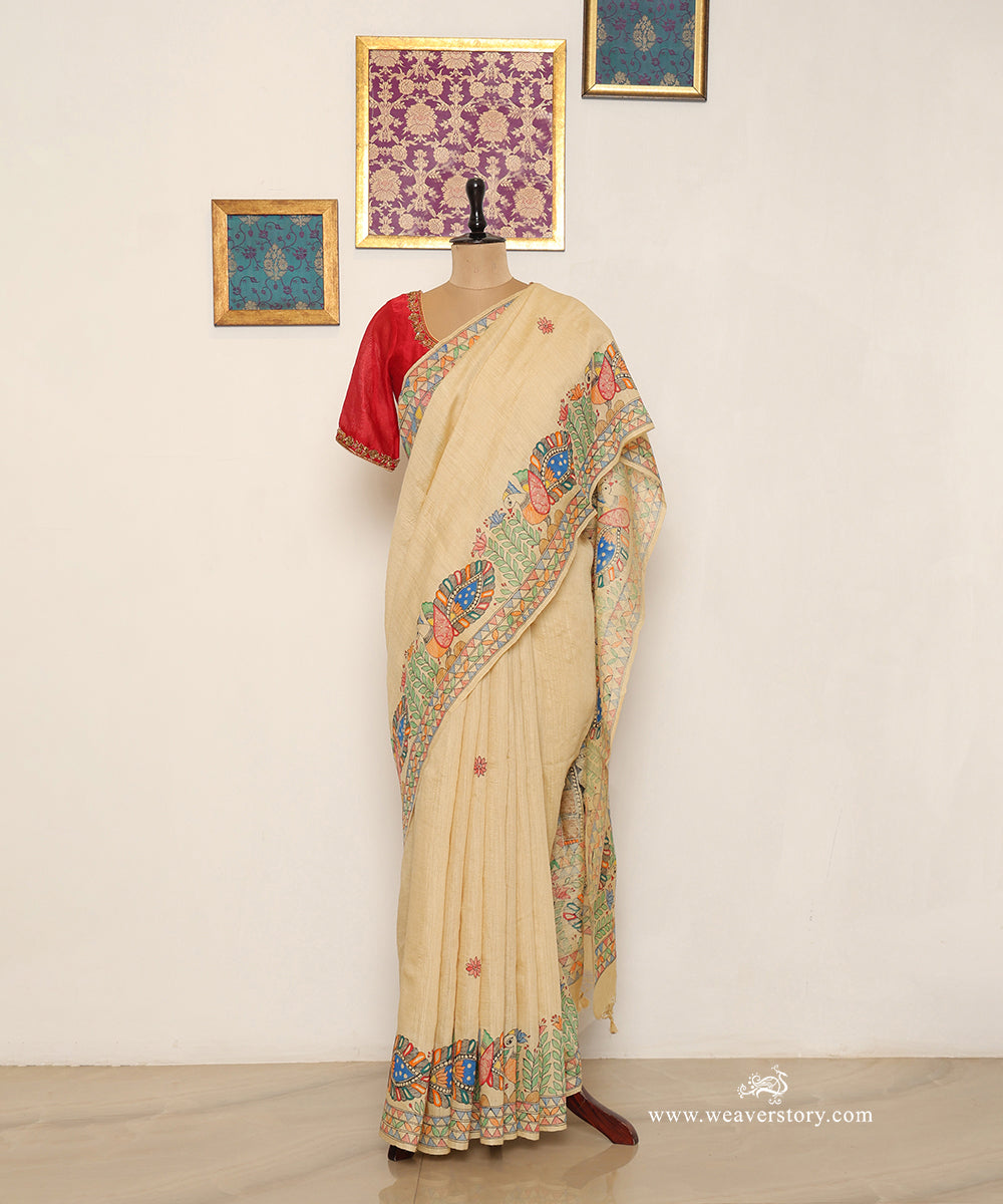 Full drape of beige gold Chanderi saree with Madhubani birds along the border and scattered floral motifs.