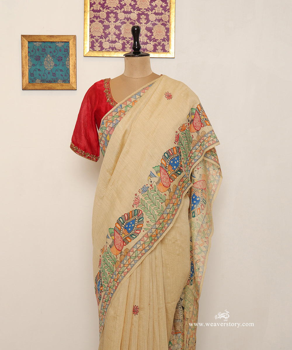 Beige gold Chanderi shoulder drape showing finely patterned Madhubani birds in red, blue and orange.