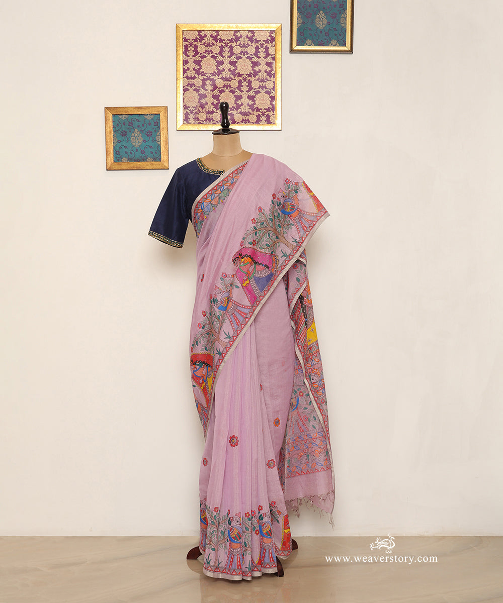 Mauve handloom Chanderi saree with painted village women, trees and scattered flowers.