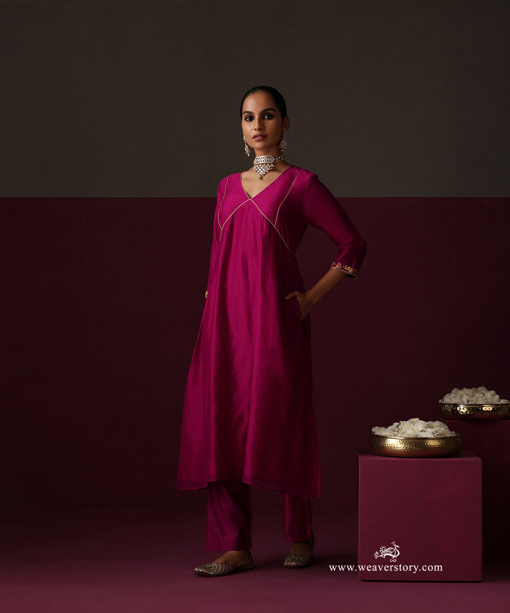 Close-up of the gold-piped bodice panels and floral hand embroidery at the kurta cuff