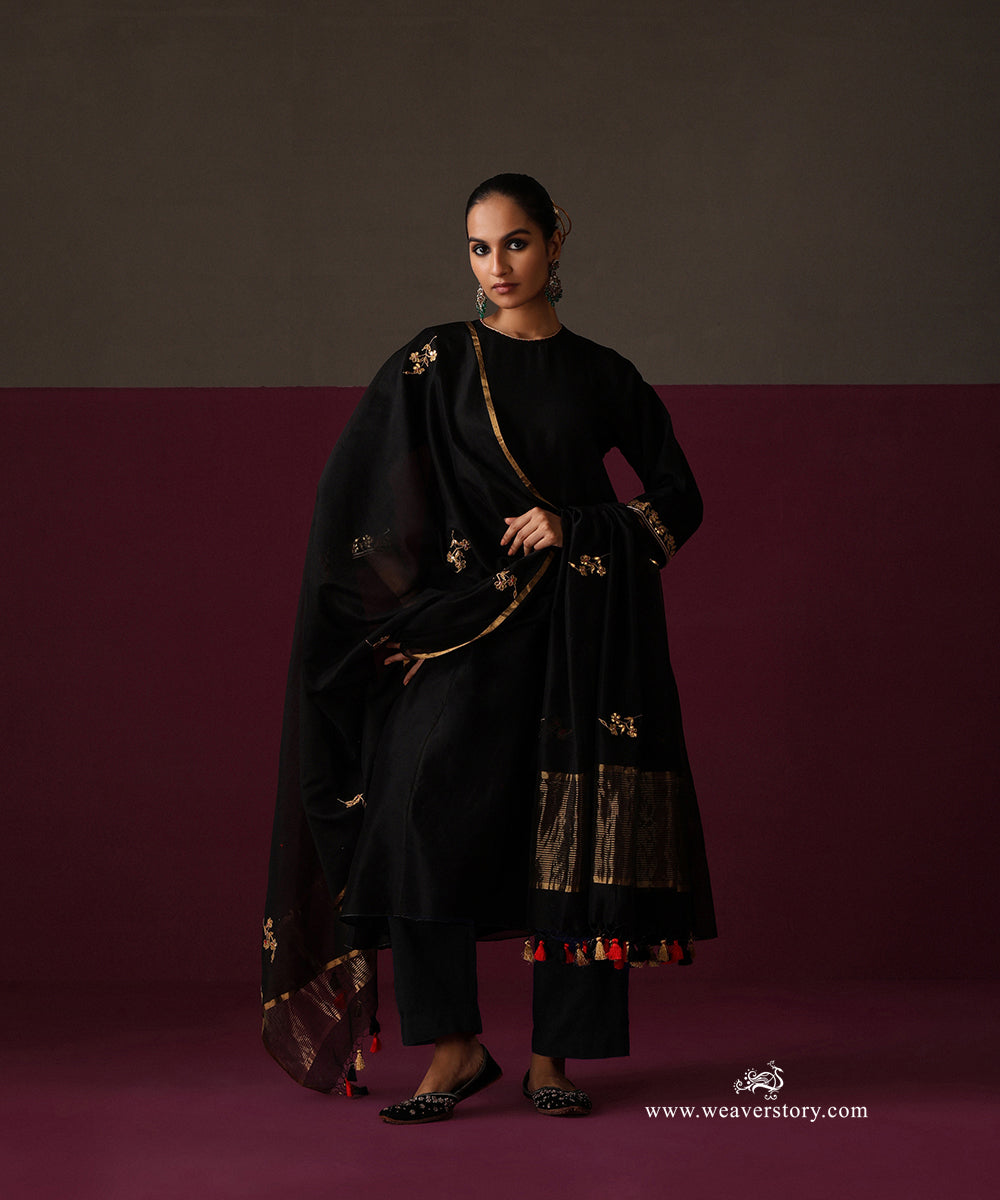 Model wearing the gently flared black Chanderi kurta with embroidered three-quarter sleeve cuffs