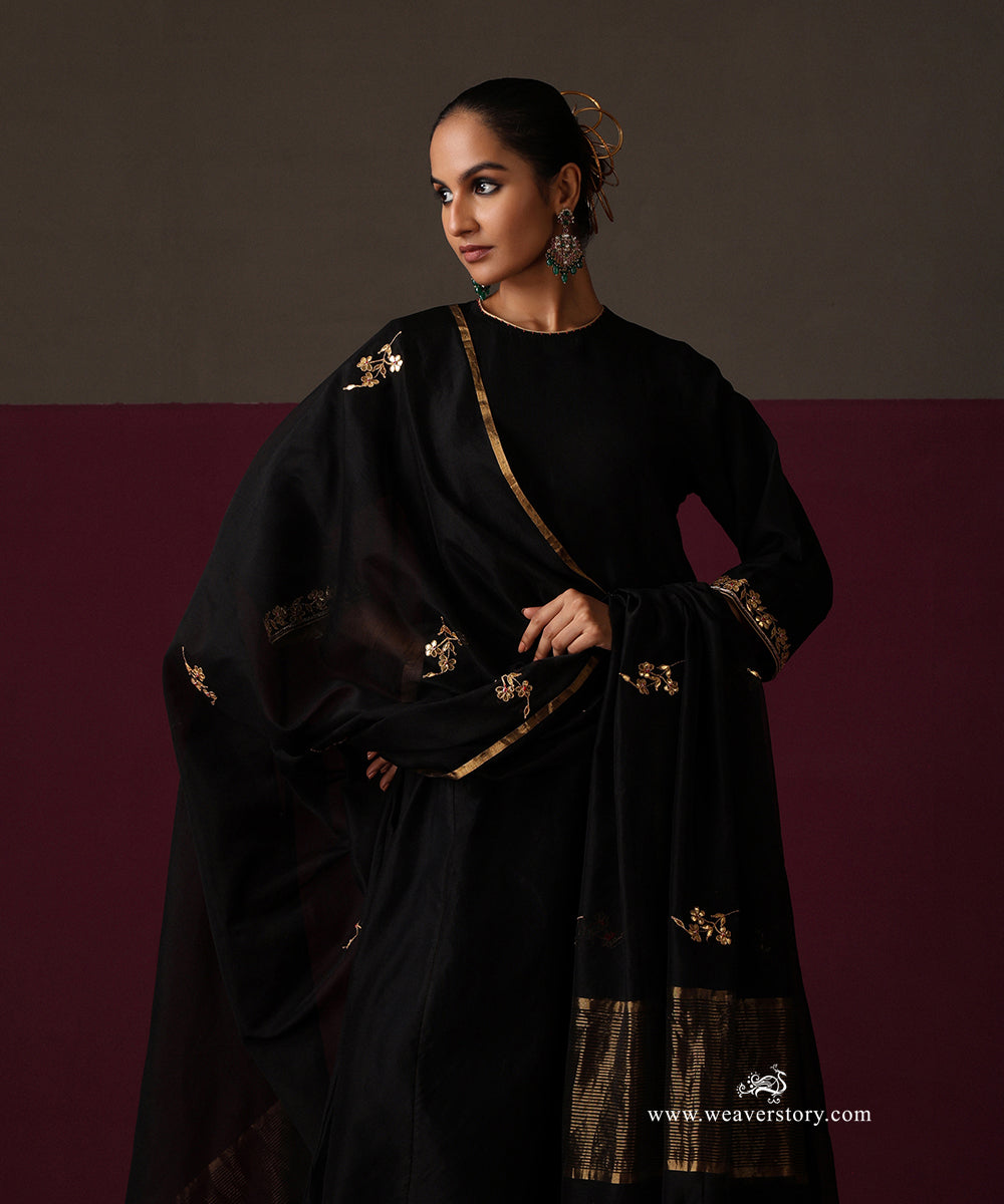 Model wearing Nayab, a black Chanderi suit with floral embroidered dupatta and striped gold border