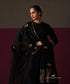 Model wearing Nayab, a black Chanderi suit with floral embroidered dupatta and striped gold border
