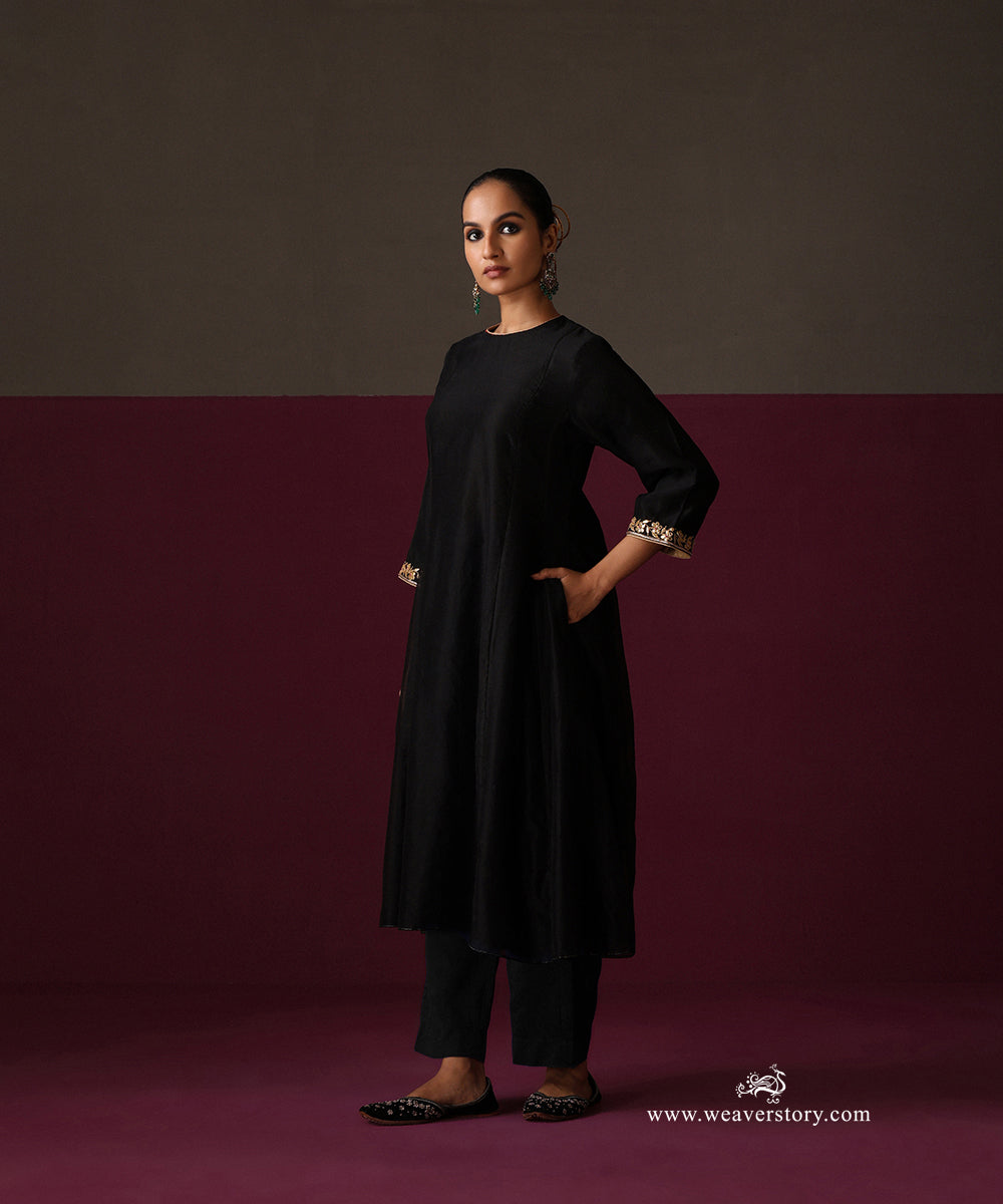 Side view of the black Chanderi kurta, straight pants and gold-bordered floral dupatta
