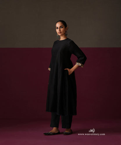 Side view of the black Chanderi kurta, straight pants and gold-bordered floral dupatta