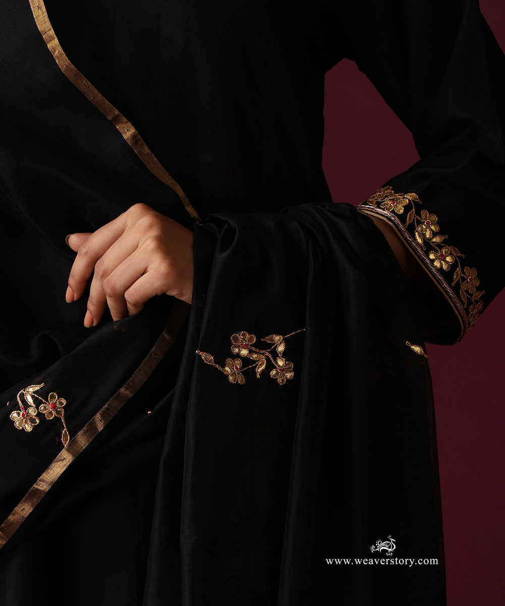Close-up of gold floral motifs spaced across the black dupatta