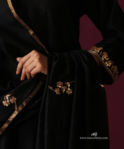 Close-up of gold floral motifs spaced across the black dupatta