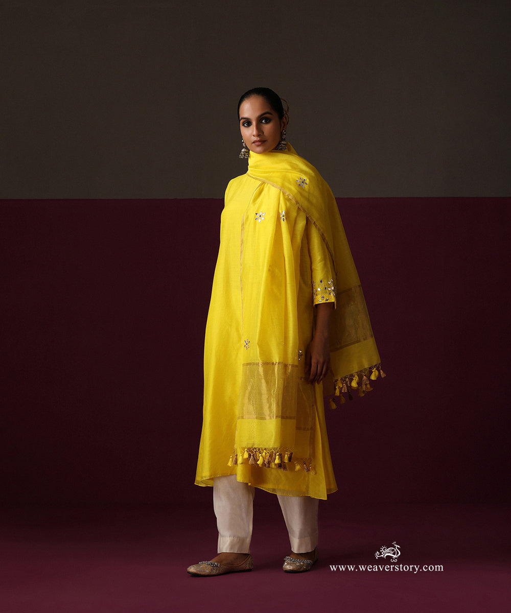 Model wearing Ziya, a yellow A-line Chanderi suit with floral dupatta and white straight pants