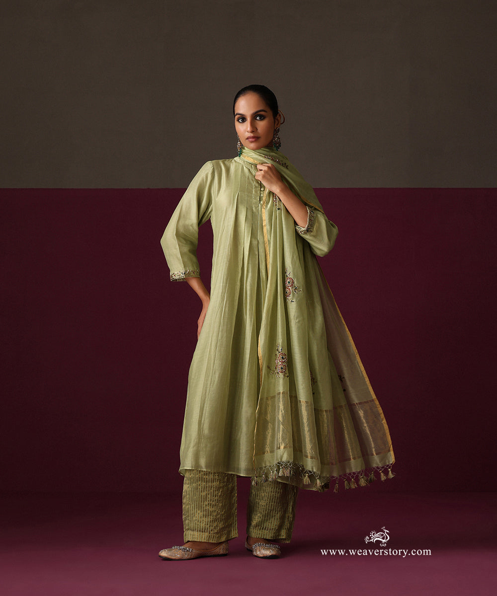 Model wearing Ruhani, a pista green pleated Chanderi suit with striped tissue pants and embroidered dupatta