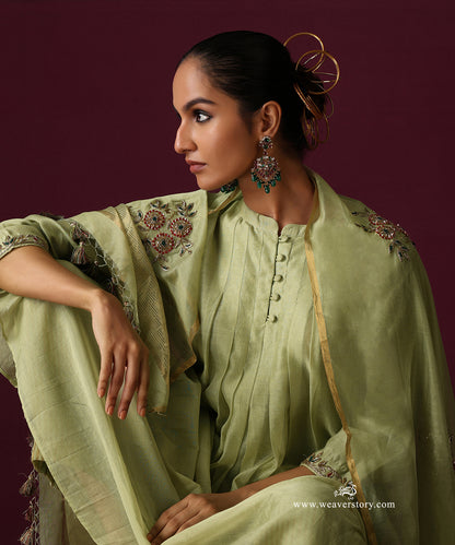 Close-up of the pleated kurta front, fabric-covered buttons and floral embroidery on the pista green dupatta