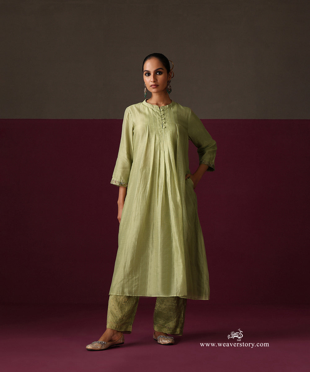 Front view of the pista green pleated kurta with embroidered cuffs and striped Chanderi tissue pants