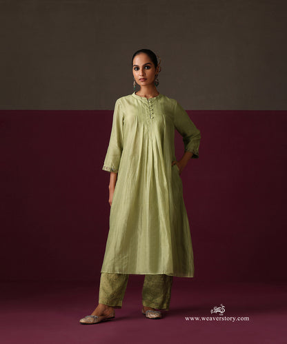 Front view of the pista green pleated kurta with embroidered cuffs and striped Chanderi tissue pants