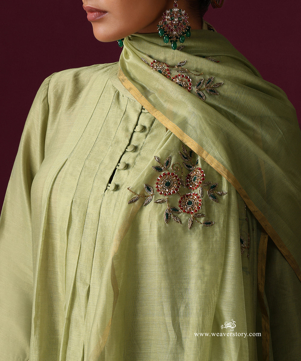 Detail of floral zardozi embroidery with red and green accents on the pista green dupatta